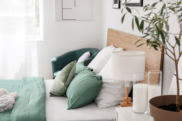 Layered quilt cover set with coordinated pillows in a styled bedroom