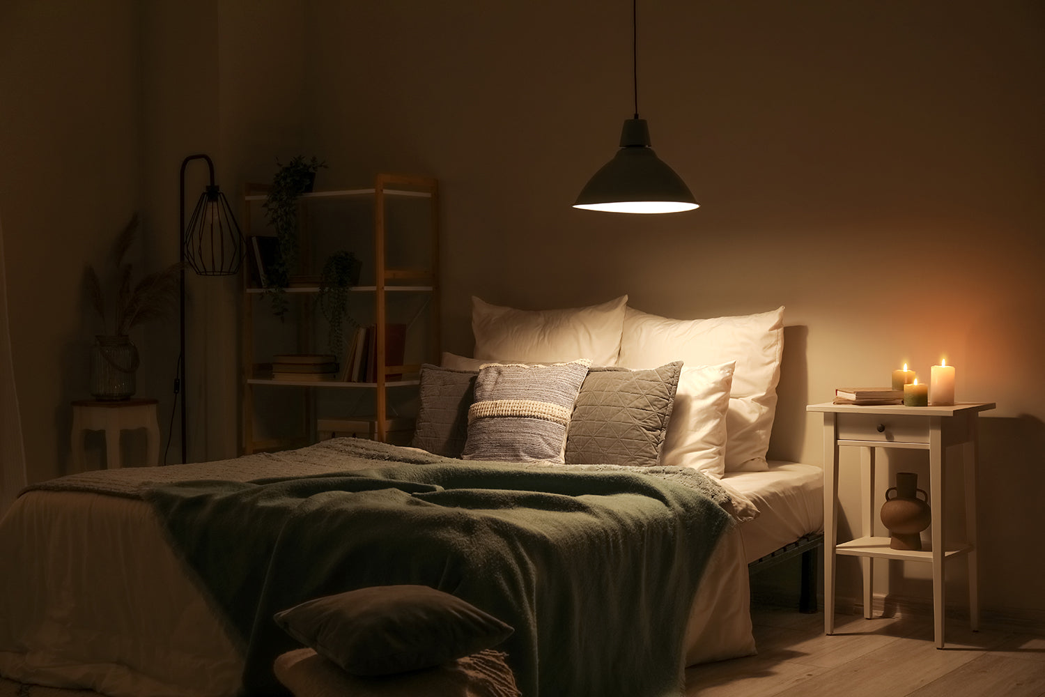 Calm bedroom with soft lighting, uncluttered surfaces and layered bedding