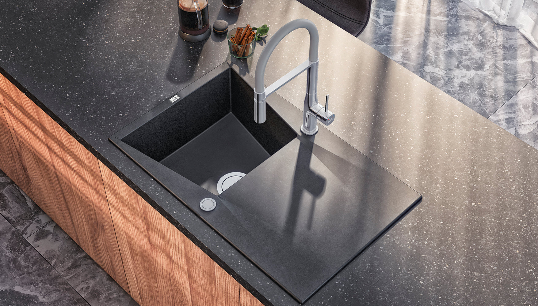 Granite kitchen sink being cleaned to maintain its finish
