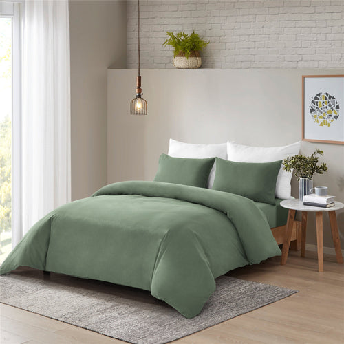 Sage green washed cotton quilt cover set in a modern bedroom