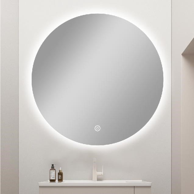 Round illuminated bathroom mirror on a white wall with minimal decor.