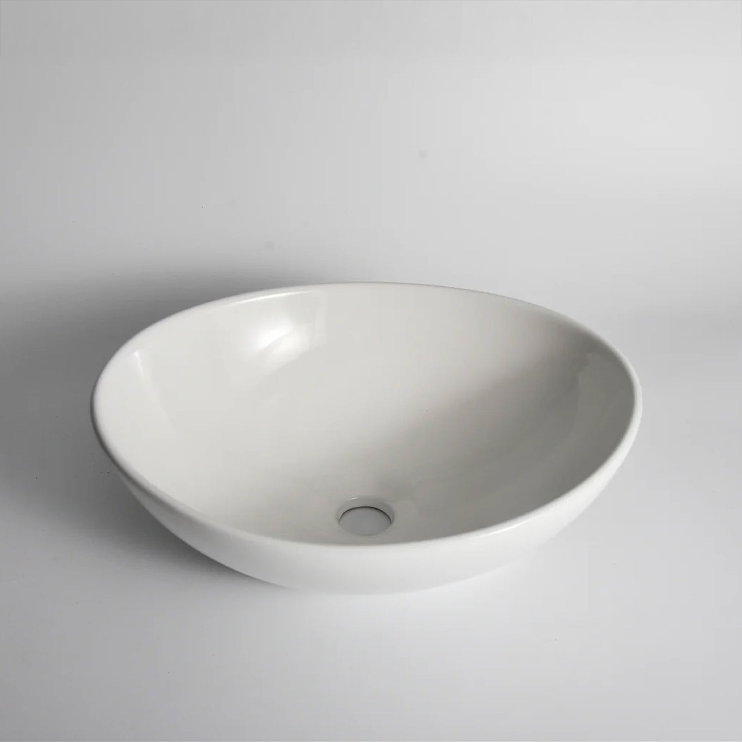CLAYA Oval-40 above counter basin in gloss white ceramic. 410mm oval basin with non-overflow waste, ideal for modern bathroom vanities.-Basin Sink-Ezymall AU