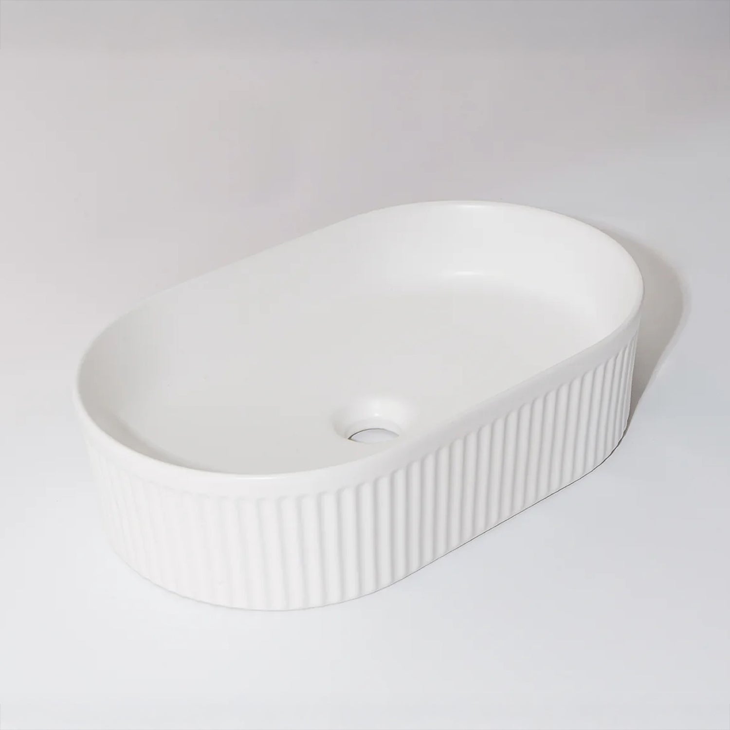 CLAYA Pill-49 fluted above counter basin in matte white ceramic. 490mm oval basin with vertical fluting and overflow for modern bathrooms.-Basin Sink-Ezymall AU