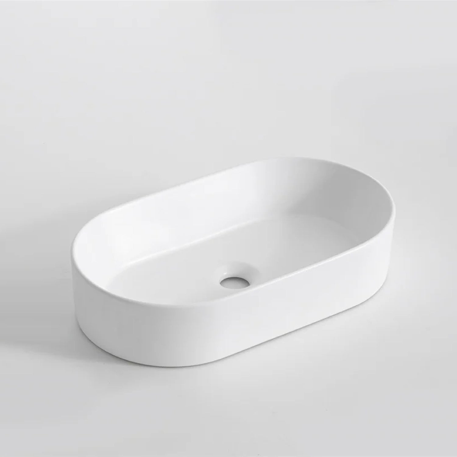 CLAYA Pill-52 above counter basin in gloss white ceramic. Slim 525mm oval basin with non-overflow waste for modern bathroom vanities.-Basin Sink-Ezymall AU