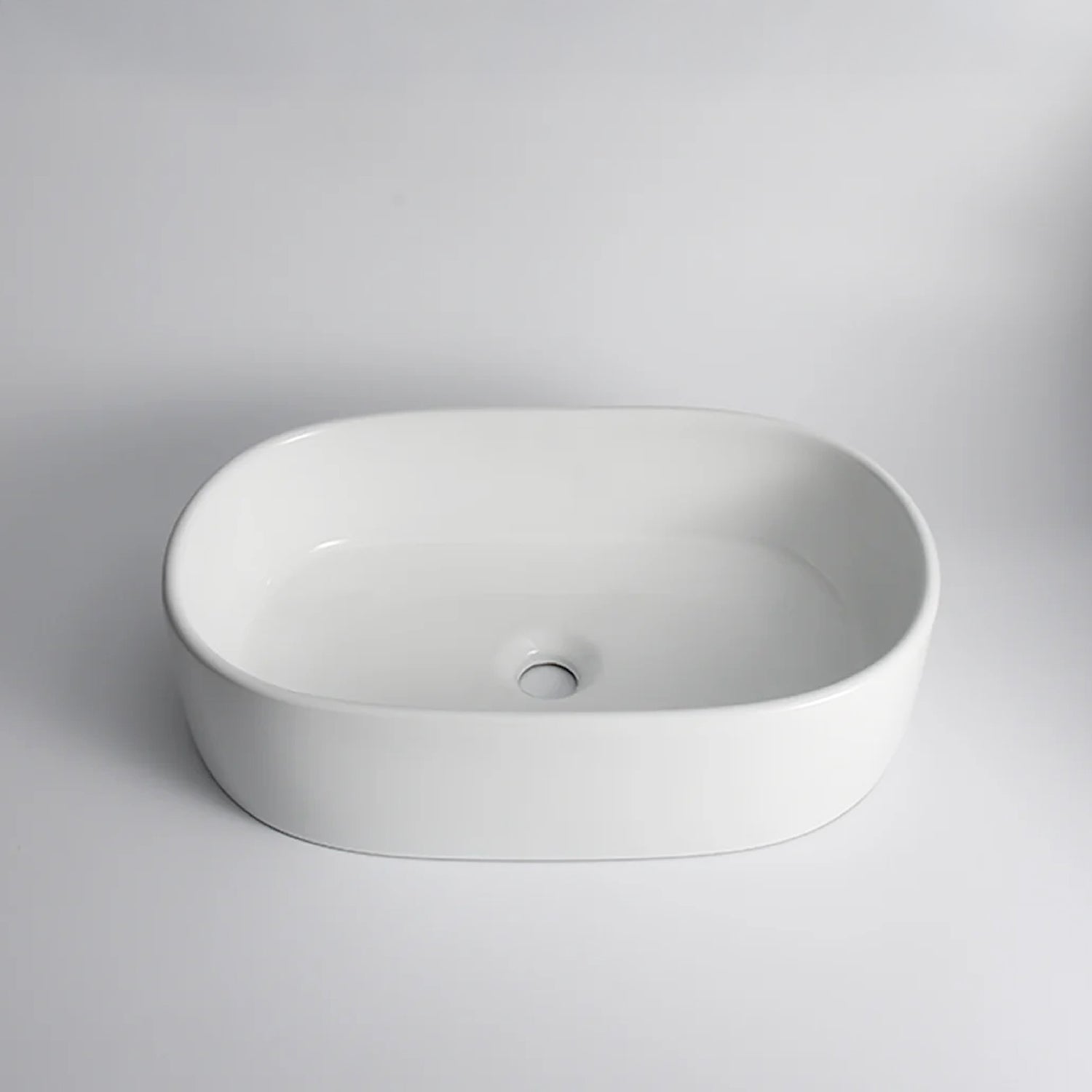 CLAYA Pill-56 above counter basin in gloss white ceramic. 560mm oval basin with non-overflow waste for modern bathroom vanities.-Basin Sink-Ezymall AU