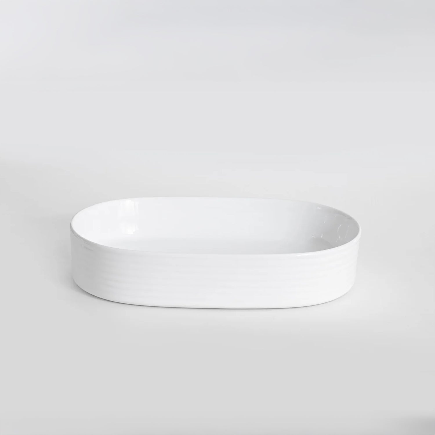 CLAYA Pill-60 fluted above counter basin in gloss white ceramic. 605mm oval basin with non-overflow waste for modern bathroom vanities.-Basin Sink-Ezymall AU