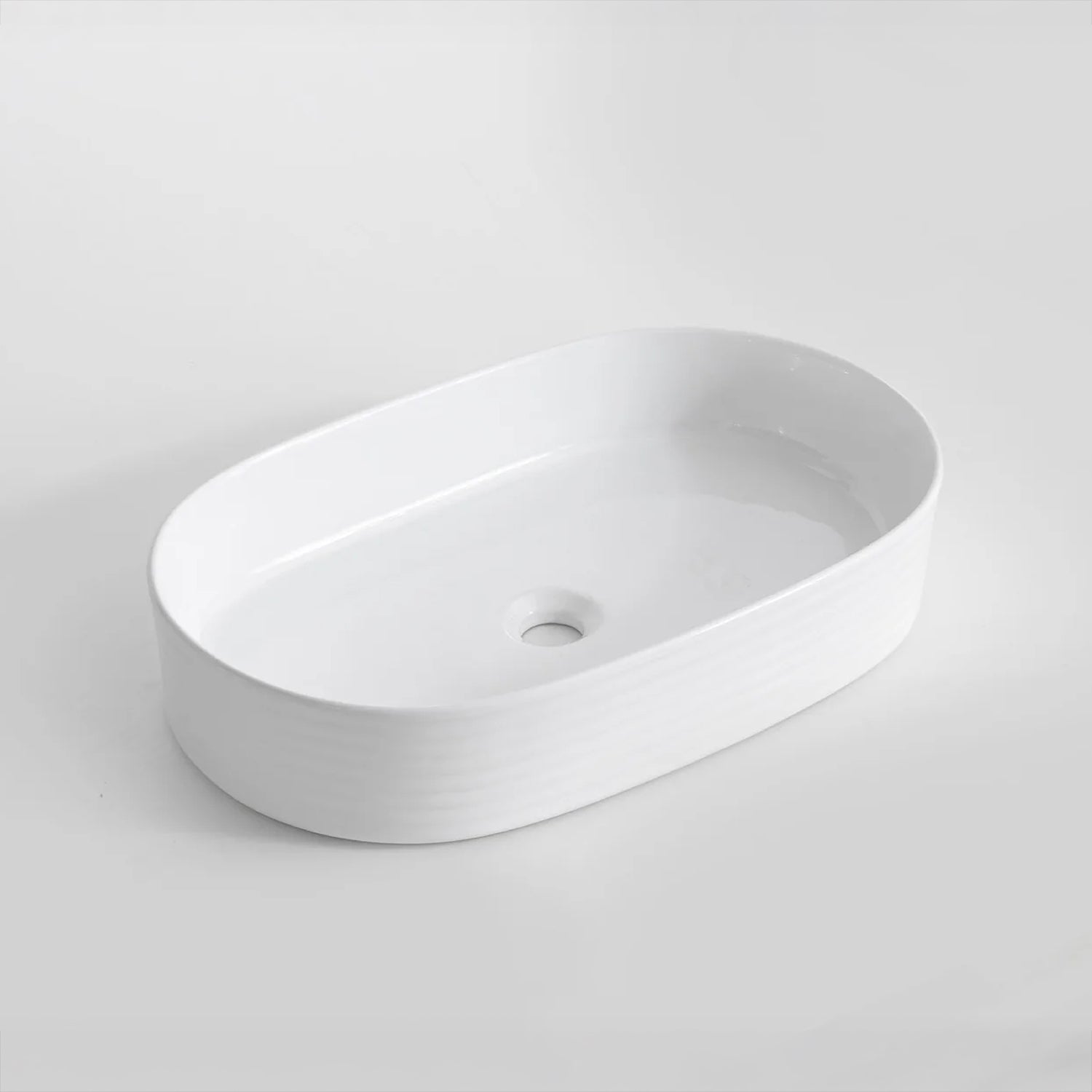 CLAYA Pill-60 fluted above counter basin in gloss white ceramic. 605mm oval basin with non-overflow waste for modern bathroom vanities.-Basin Sink-Ezymall AU