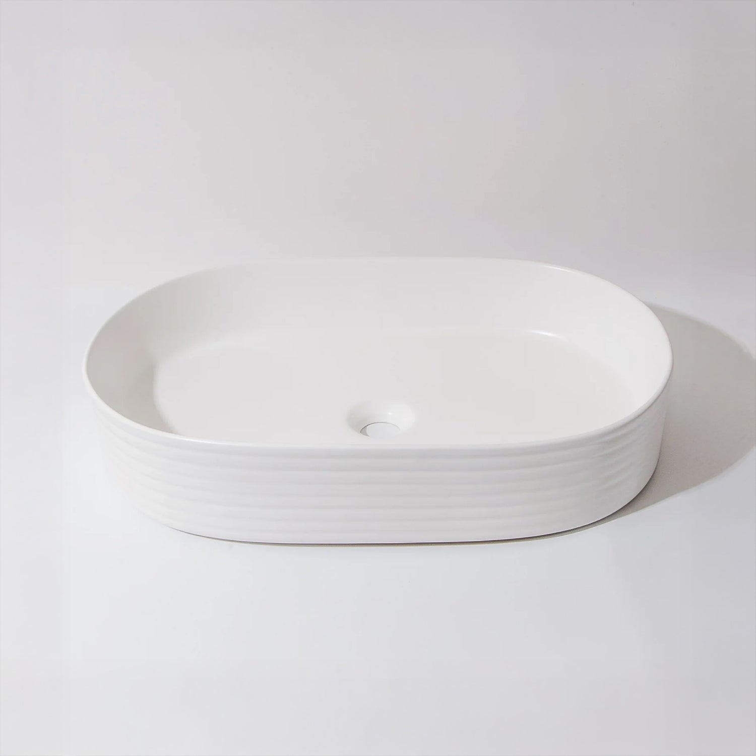 CLAYA Pill-60 fluted above counter basin in matte white ceramic. 605mm oval basin with non-overflow waste for modern bathroom vanities.-Basin Sink-Ezymall AU