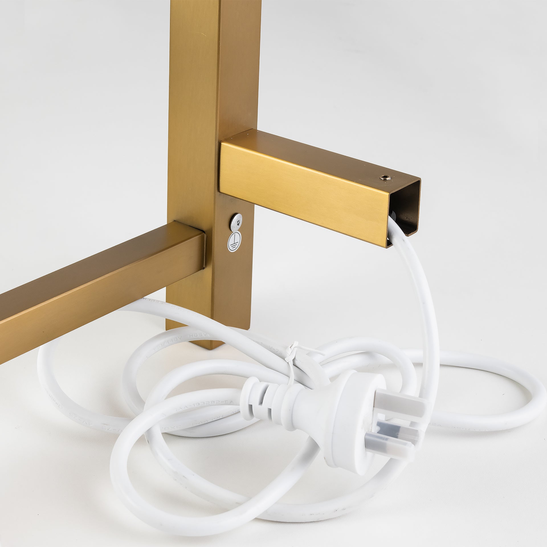 Close-up of Brushed Brass Gold stainless steel 4-bar square heated towel rail